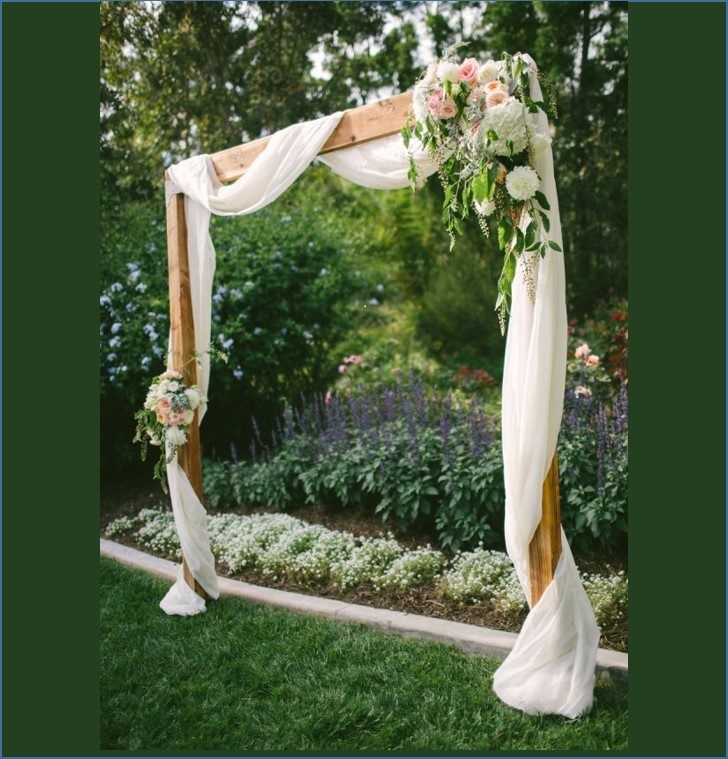 Light timber arbour with muslin swag