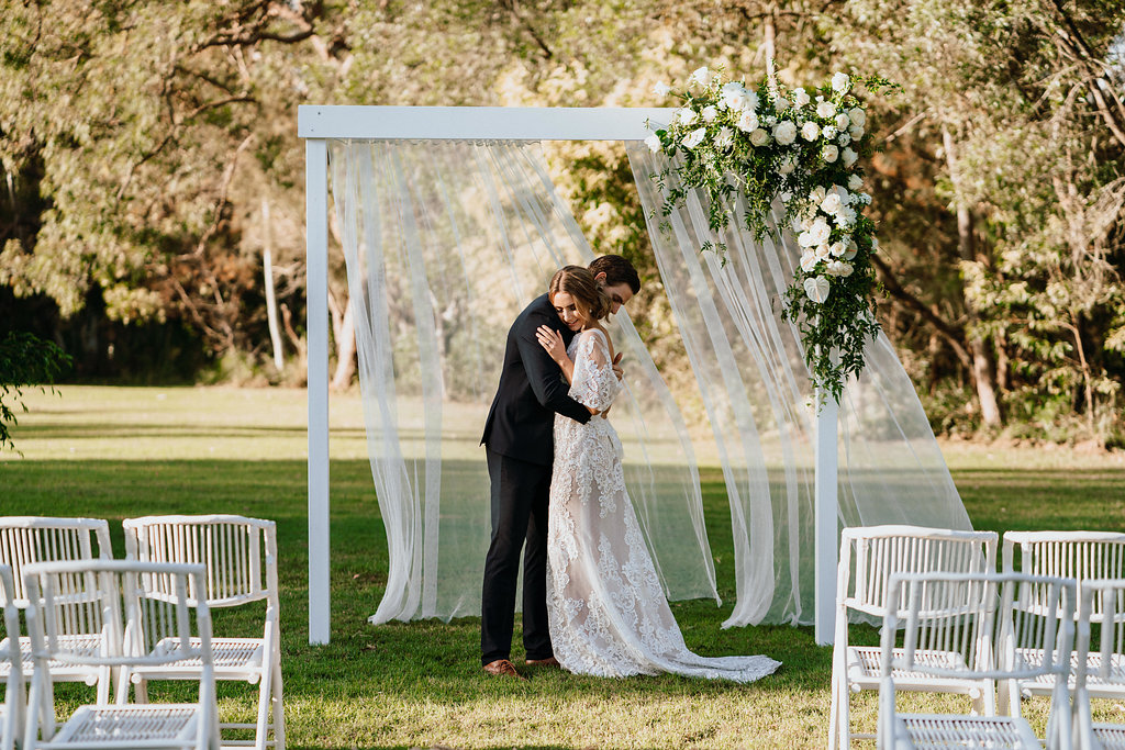 White timber arbour with curtains