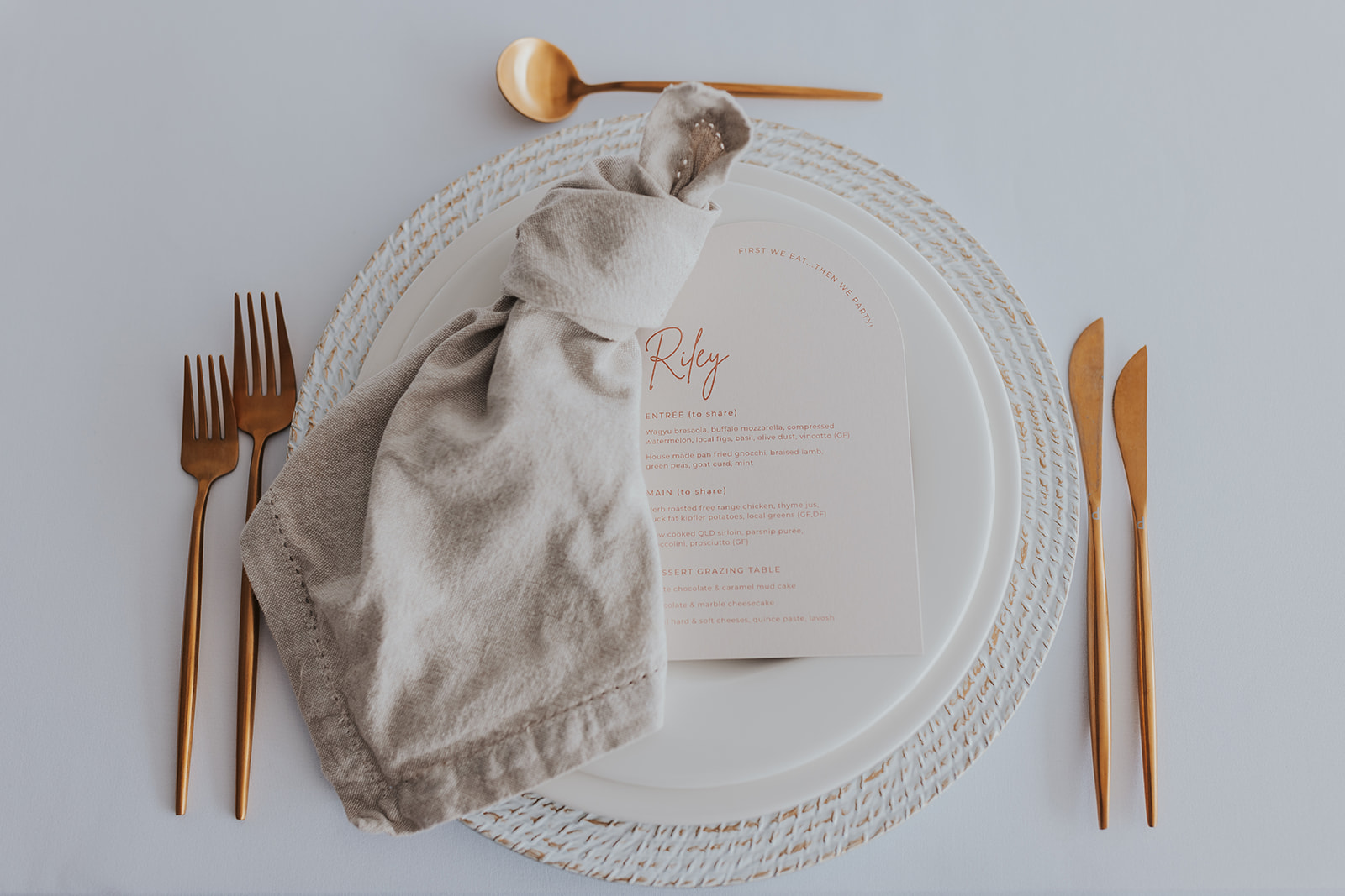 White washed Charger, natural napkin, gold cutlery