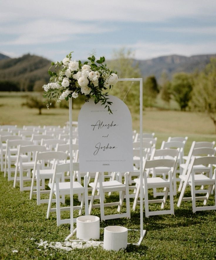 Arched welcome sign on white stand